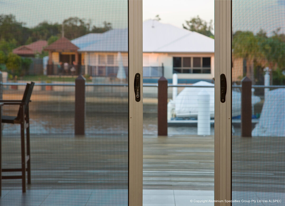 Alu-Gard aluminium sliding doors with a view of the water in the background